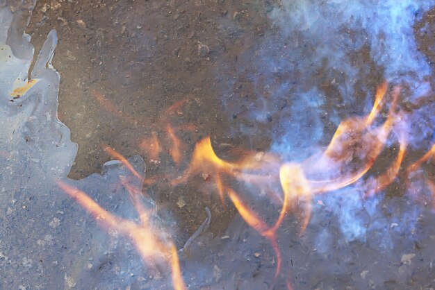 background oil spill burning fire, pollution ecology toxic fire gasoline