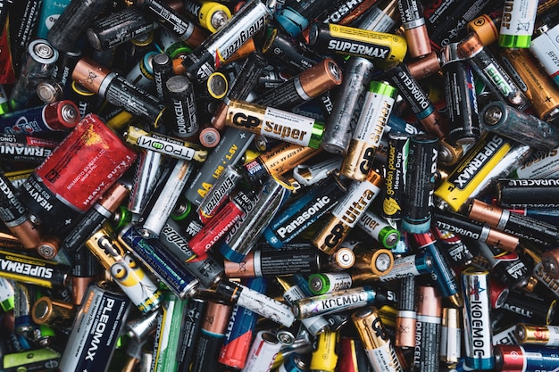 background  old used discarded AA cells and other electric batteries