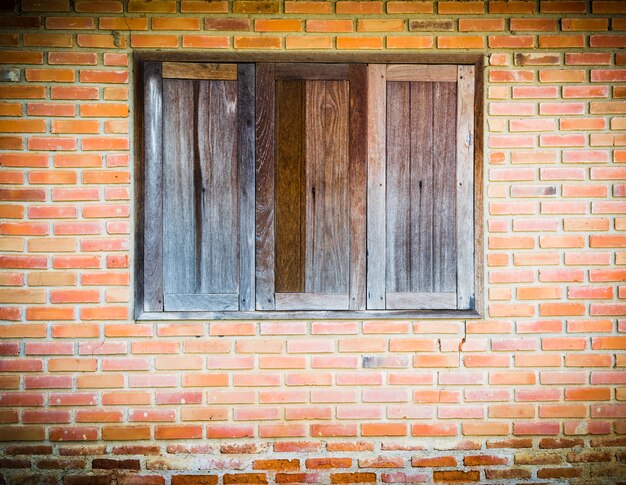 Background of old vintage brick wall and wooden window