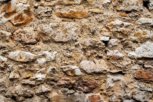 Background pattern Rustic natural stones wall with green moss and plants