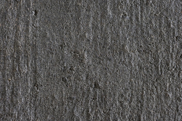 Background, photo of a texture from a building material of gray color, concrete, close-up.