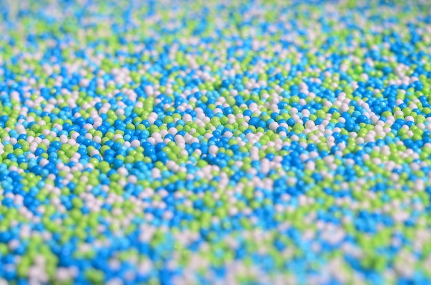 Background picture of a variety of colored glazed powder in the form of small balls