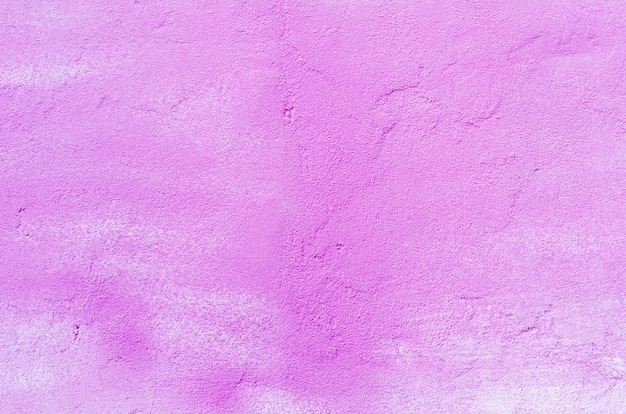 Background of a pink stucco coated and painted exterior, rough cast of cement and concrete wall texture, decorative coating