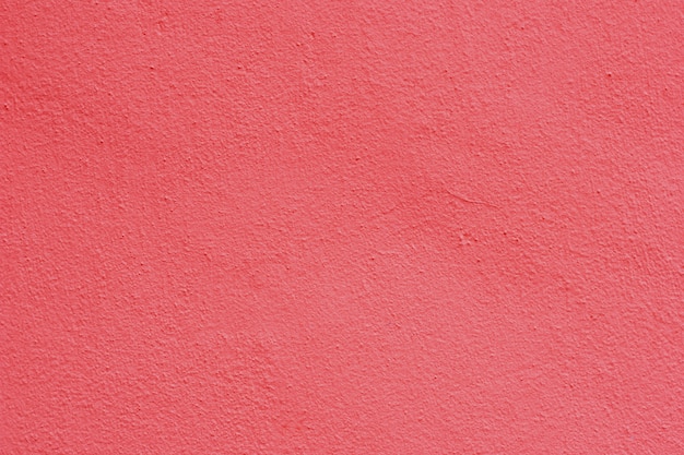 Background of a pink stucco coated and painted exterior, rough cast of cement and concrete wall texture