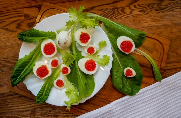 Background of red caviar on dsrk wooden surface tartlets with red caviar