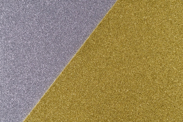 Background of shiny gray and golden paper in bright colors geometric pattern