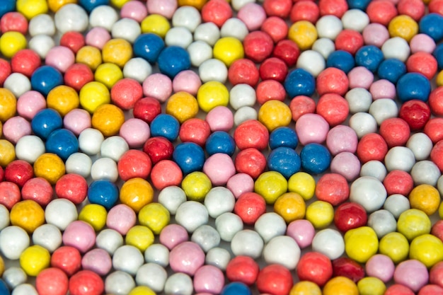 Background of small round multi-colored sweets.