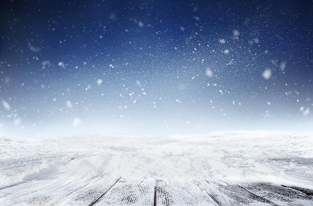 Background of snowy wooden table at night