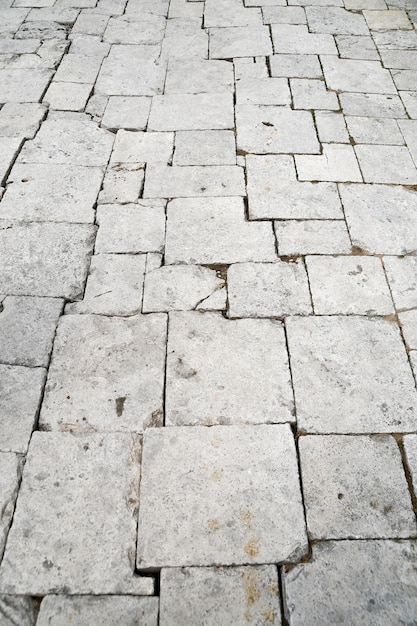 Background stone texture The road paved with large stone flat slabs