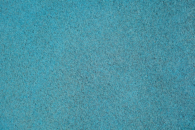 Background texture of blue crumb rubber used for athletic tracks and children playgrounds