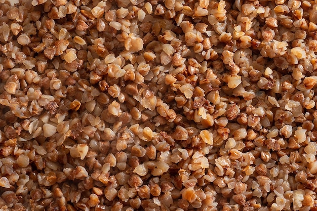 Background texture from Grains of brown natural boiled readytoeat buckwheat Diet product Healthy food and nutrition concept