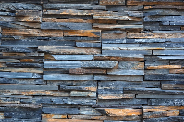 Background and texture of multicolor cladding stone slate wall in loft style