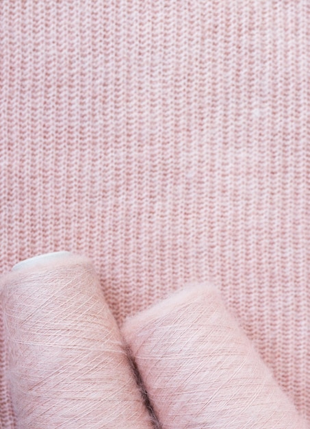 Background texture of pink pattern knitted fabric made of angora or wool.