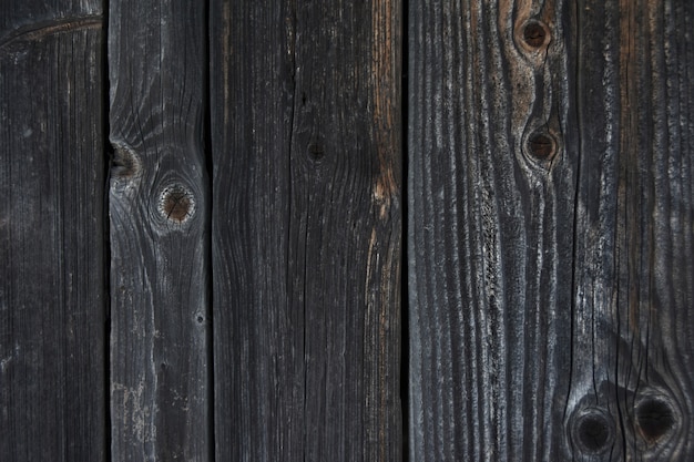 Background texture of a wall of old wooden logs and boards