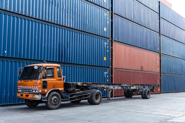 Background of truck at container warehouse preparing to lift cargo boxes