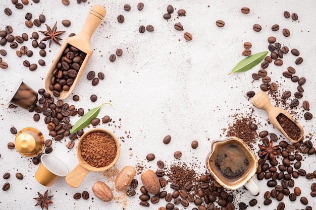 Background of various coffee dark roasted coffee beans ground setup on white background.