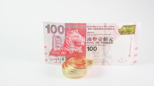 Background with Bitcoin cryptocurrency coins and Hong Kong dollar Bitcoin cryptocurrency concept Bitcoin BTC virtual money and Hong Kong dollar banknotes