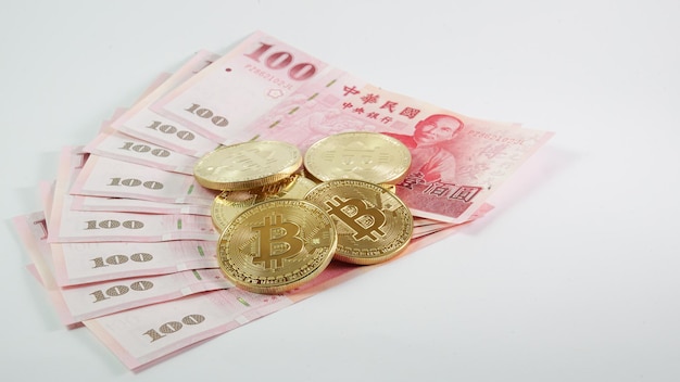 Background with Bitcoin cryptocurrency coins and Taiwan Dollar Bitcoin cryptocurrency concept Bitcoin BTC virtual money and Taiwan Dollar banknotes