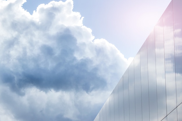 Background with blue skies and glass building.