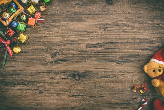 Background with christmas bear and gift boxes decoration. Top view with copyspace on wood table on Christmas holiday concept.