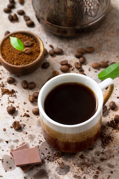 Background with Coffee cup and beans on concrete table