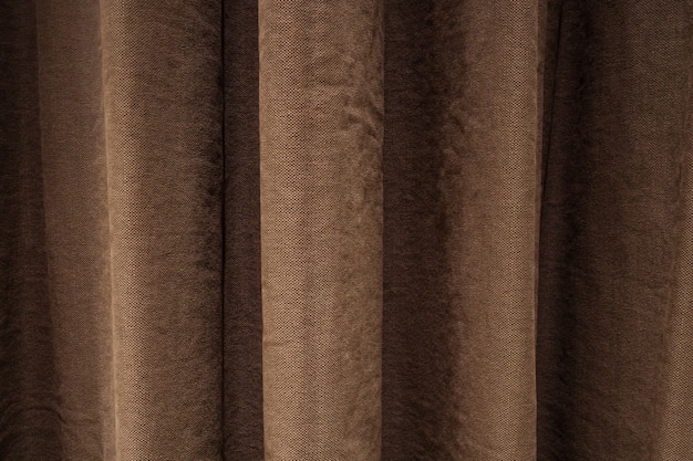 Background with curtain of brown color hanging and forming drapery