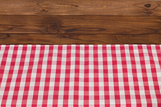 Background with empty wooden table with tablecloth