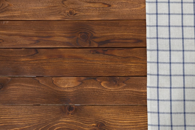 Background with empty wooden table with tablecloth