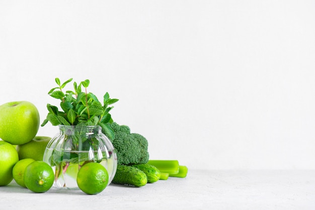 Background with fresh green vegetables and fruits