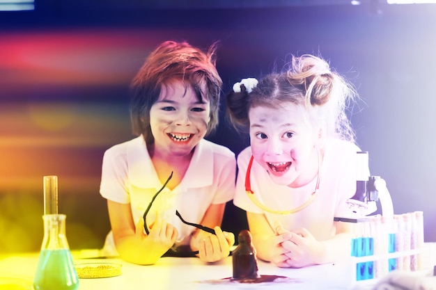 Background with highlights of children of scientists A boy and a girl are experimenting in the laboratory