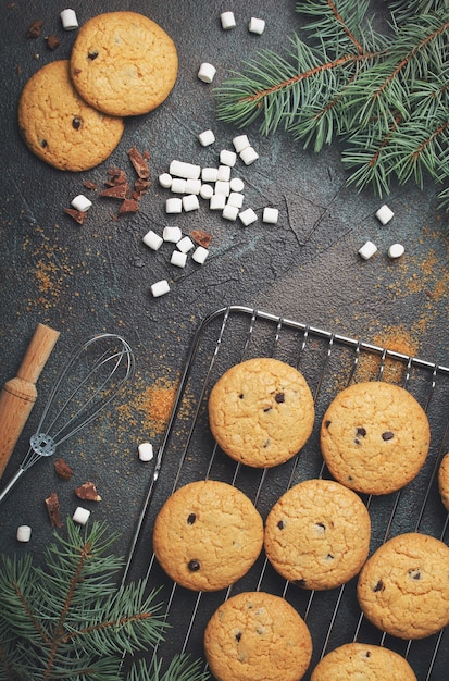 Background with homemade Chocolate Chip Cookies and marshmallows. Christmas food frame.