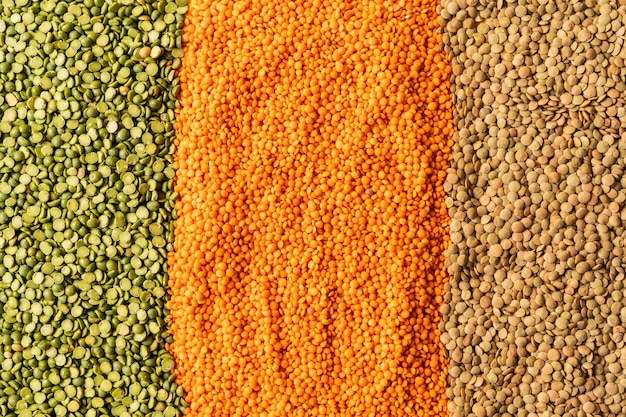 Background with lentils seeds of annual legume plant, they are rich in vegetable protein.