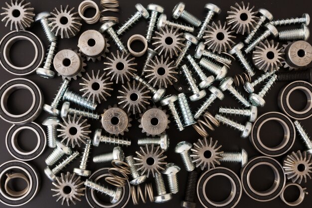 Background with mechanical components, gears, springs, screws, industrial objects