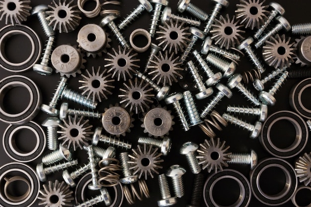 Background with mechanical components, gears, springs, screws, industrial objects