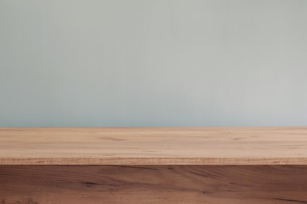 Background with modern wooden table and blue wall