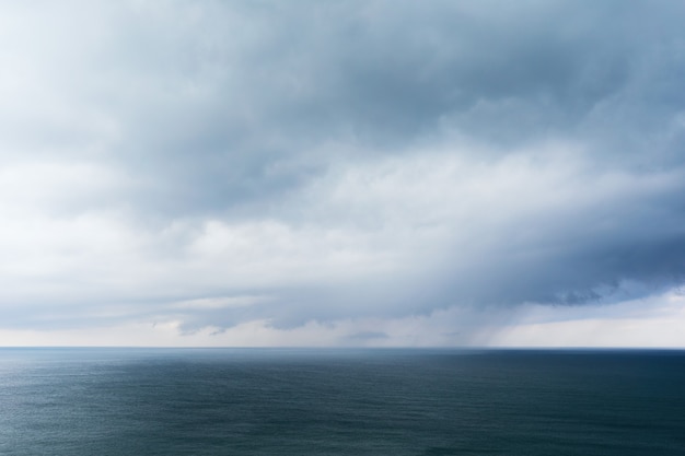 Background with rain clouds on the sea