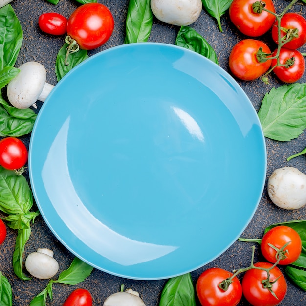 Background with tomatoes, champignons and basil leaves