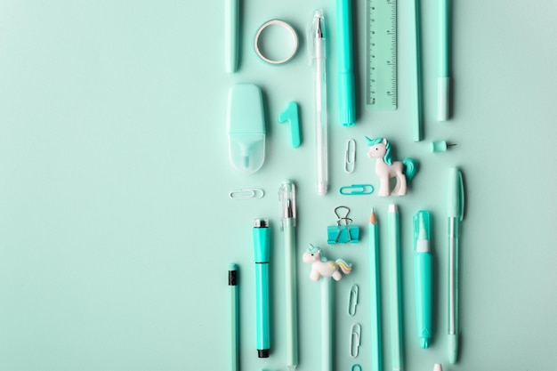 Background with various turquoisecolored stationery lying on its side