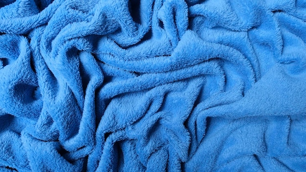 Background of wrinkled sea blue blanket with soft and warm texture for winter