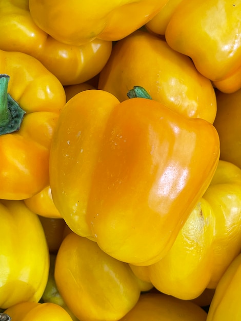 Background yellow chili peppers on a showcase close up