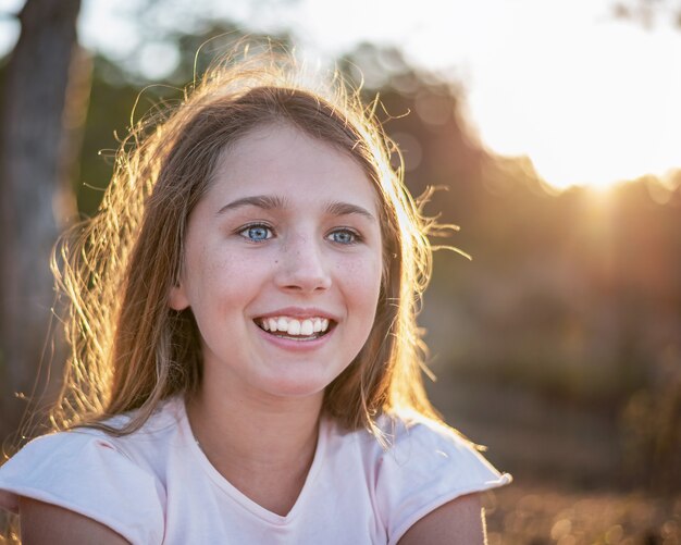 Backlight portrait of a young happy girl