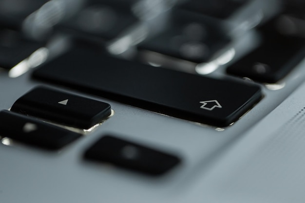 Backlit computer keyboard with focus on shift button closeup