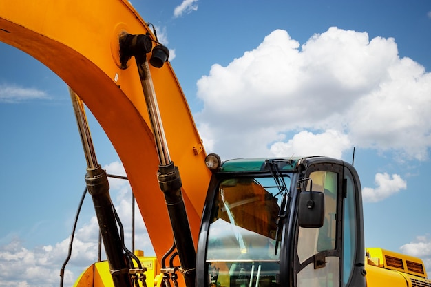 Backlit excavator on an industrial site against the background of the evening sky Construction machinery for earthworks