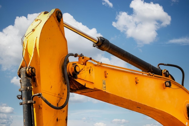 Backlit excavator on an industrial site against the background of the evening sky Construction machinery for earthworks