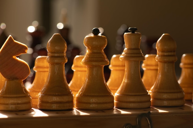 Backlit white chess pieces on game board