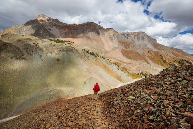 Backpacker in hike in the autumn mountains