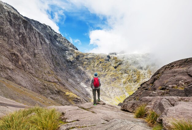 Backpacker in hike in the high mountains