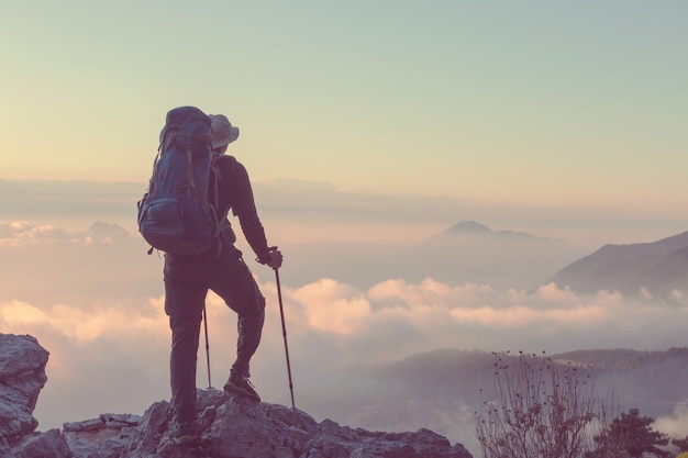 Backpacker in a hike in the summer mountains