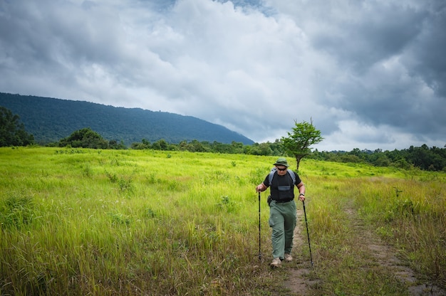 Backpacker trekking to study nature of tropical forest for ecotourism. Tourist trekking to see the beauty of the tropical forest in Khao Yai National Park. UNESCO World Heritage Area, Unseen Thailand.