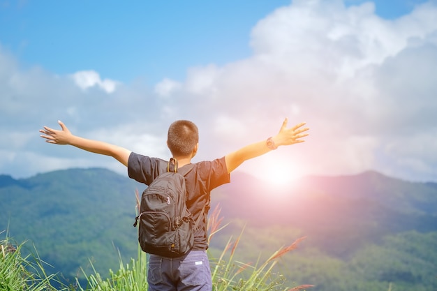 backpackers boy on the nature of the mountains is worth looking at a view